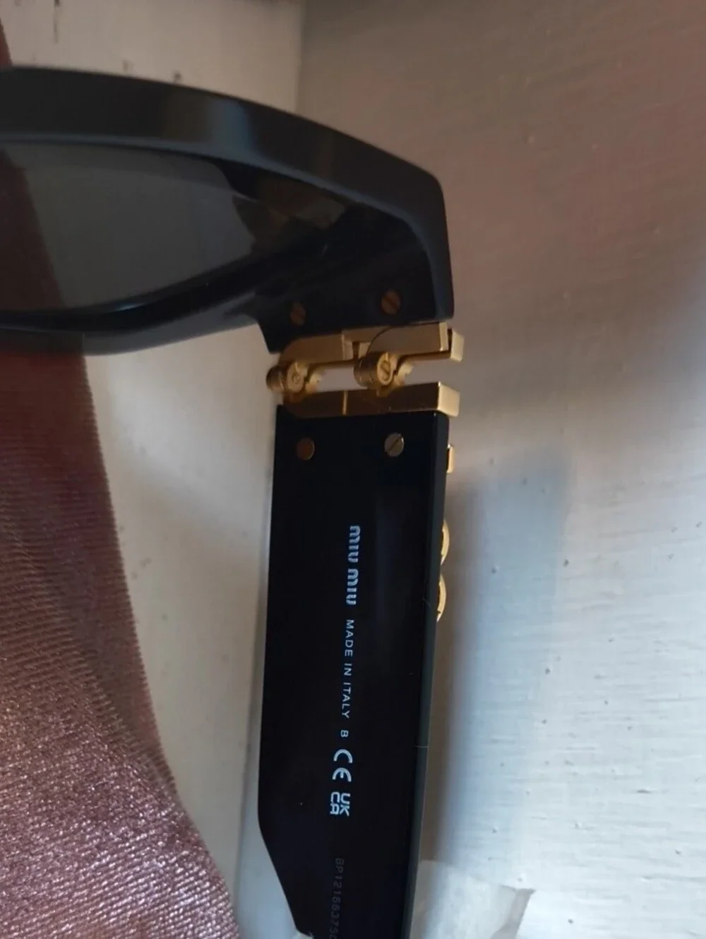 Miu Miu Black Sunglasses with Gold Logo Accent